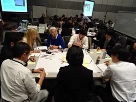 Gathering of people around tables