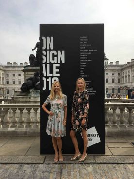 2 woman in front of a poster