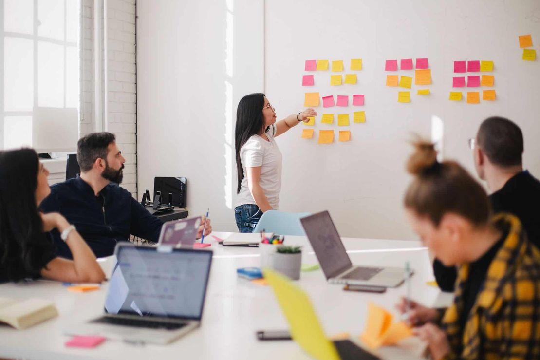 People attending a seminar with post-it's on the wall